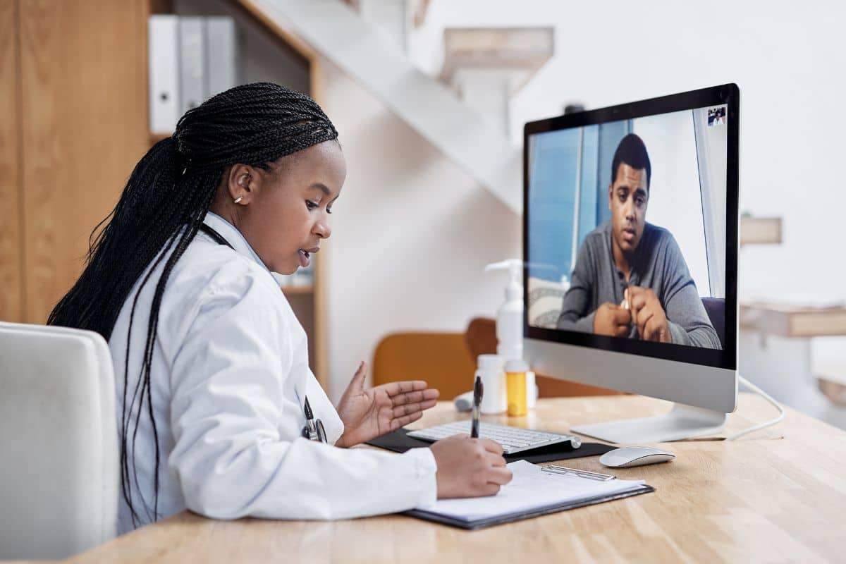 doctor writing ESA prescription after telehealth evaluation doctor writing ESA prescription after telehealth evaluation