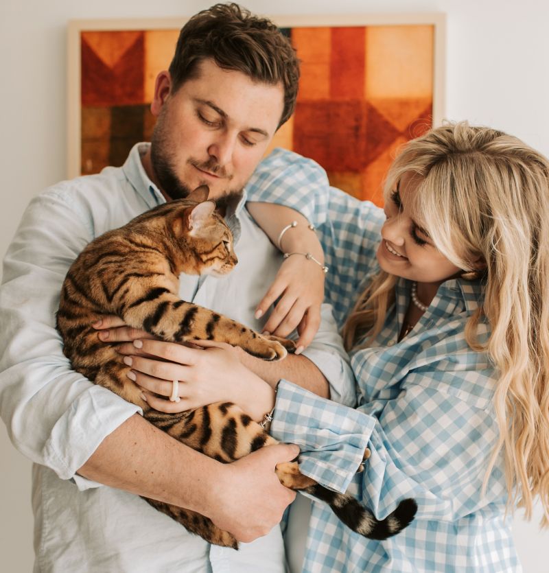 Couple Holding Bengal Cat Couple Holding Bengal Cat